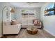 Cozy living room with a comfortable white sectional sofa, stylish rug, and large windows for natural light at 522 31St W St, Bradenton, FL 34205