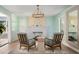 Well-lit living room features two chairs facing an elegant fireplace and a large window with plantation shutters at 522 31St W St, Bradenton, FL 34205