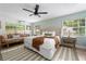 Inviting main bedroom featuring a plush king bed, a ceiling fan, and natural light at 522 31St W St, Bradenton, FL 34205