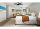 Inviting main bedroom featuring a plush king bed, a ceiling fan, and natural light at 522 31St W St, Bradenton, FL 34205