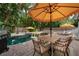A beautiful backyard pool area features lounge chairs and a barbecue grill for outdoor entertaining at 522 31St W St, Bradenton, FL 34205