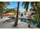 Beautiful pool area with in-ground pool, hot tub, lounge chairs, and lush landscaping at 522 31St W St, Bradenton, FL 34205