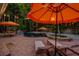 Outdoor oasis boasts a pool, spa, lounge chairs, and dining area under festive string lights and umbrellas at 522 31St W St, Bradenton, FL 34205