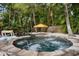 An inviting backyard pool and spa surrounded by lush tropical landscaping, perfect for relaxation at 522 31St W St, Bradenton, FL 34205