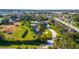 Expansive aerial view of the property, showcasing the lake, lush landscaping, and surrounding neighborhood at 5311 36Th E Ave, Palmetto, FL 34221