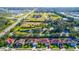 Wide aerial perspective showing the expansive green areas, the lake, and the surrounding residential area at 5311 36Th E Ave, Palmetto, FL 34221