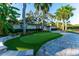Florida home with a putting green, beautifully landscaped yard, and a welcoming paver patio at 5311 36Th E Ave, Palmetto, FL 34221