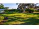 Lush backyard featuring a well-manicured lawn and mature trees providing ample shade and privacy at 5311 36Th E Ave, Palmetto, FL 34221