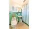 Vintage bathroom with green tile, classic fixtures, and patterned shower curtain at 5311 36Th E Ave, Palmetto, FL 34221