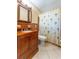Bathroom with wood vanity, and shower with palm tree shower curtain at 5311 36Th E Ave, Palmetto, FL 34221