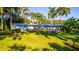 Well-maintained single-story home with a green lawn and mature palm trees in the background at 5311 36Th E Ave, Palmetto, FL 34221