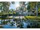Beautiful waterfront home with a private beach, lush landscaping, and serene pond view at 5311 36Th E Ave, Palmetto, FL 34221