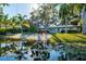 Beautiful waterfront home with a private beach, lush landscaping, and serene pond view at 5311 36Th E Ave, Palmetto, FL 34221