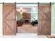 View of Gathering room with sliding barn doors, a brick fireplace, and neutral carpet at 5311 36Th E Ave, Palmetto, FL 34221