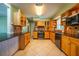 Open kitchen design with tile floor, stainless oven, light wood cabinets, and dark countertops at 5311 36Th E Ave, Palmetto, FL 34221