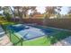 Fenced outdoor pickleball court with a green and blue playing surface, and stone perimeter at 5311 36Th E Ave, Palmetto, FL 34221