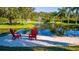 Tranquil Florida home featuring a pond with fountain and seating areas, perfect for relaxation and entertaining at 5311 36Th E Ave, Palmetto, FL 34221