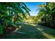 Backyard putting green with a pond view, fountain, and lush tropical surroundings at 5311 36Th E Ave, Palmetto, FL 34221