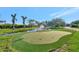 Beautiful putting green with a pond and fountain, perfect for enjoying outdoor recreation in a lush, tropical setting at 5311 36Th E Ave, Palmetto, FL 34221