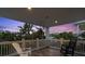 Inviting balcony offers relaxing seating with a great view of the lush tropical trees and colorful sunset at 538 Canal Rd, Sarasota, FL 34242