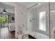 Bright bathroom featuring a glass-enclosed shower with white subway tile at 538 Canal Rd, Sarasota, FL 34242