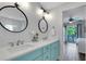 Stylish bathroom with a double vanity, modern mirrors, and access to the bedroom balcony at 538 Canal Rd, Sarasota, FL 34242