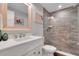Well-lit bathroom featuring a vanity with solid surface countertop and tiled glass shower at 538 Canal Rd, Sarasota, FL 34242
