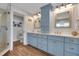 Bathroom with dual sinks, blue cabinetry, quartz countertop, and glass-enclosed shower at 538 Canal Rd, Sarasota, FL 34242