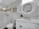 Bathroom with white tiled walk-in shower, quartz countertops, and stylish fixtures at 538 Canal Rd, Sarasota, FL 34242