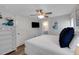 Bright bedroom with a ceiling fan, white dresser, and a flat screen television for comfortable living at 538 Canal Rd, Sarasota, FL 34242