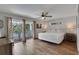 Light bedroom with a balcony, tile flooring, ensuite access, lamps, and neutral accents at 538 Canal Rd, Sarasota, FL 34242