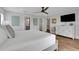 Spacious bedroom with ensuite, neutral decor, wood-look flooring, and a walk-in closet at 538 Canal Rd, Sarasota, FL 34242