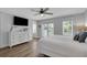 Bright bedroom with ensuite, wood-look flooring, ceiling fan, and access to a private balcony at 538 Canal Rd, Sarasota, FL 34242