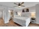 Comfortable bedroom with a ceiling fan, ensuite bathroom, and decorative artwork at 538 Canal Rd, Sarasota, FL 34242