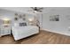 Relaxing bedroom featuring light gray walls, wood floors, and decorative wall art at 538 Canal Rd, Sarasota, FL 34242