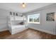Bright bunkroom featuring a large window and wood-look tile flooring at 538 Canal Rd, Sarasota, FL 34242