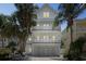 Three-story beach house showcasing multi-level balconies and a white picket railing at 538 Canal Rd, Sarasota, FL 34242