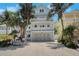 Three-story house with balconies, complemented by lush tropical landscaping at 538 Canal Rd, Sarasota, FL 34242