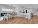 Open-concept kitchen and dining area with white cabinets, bar seating, and banquette at 538 Canal Rd, Sarasota, FL 34242