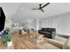 Open-concept living room with neutral tones, a ceiling fan, and hardwood floors at 538 Canal Rd, Sarasota, FL 34242