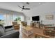 Relaxing living room with a fan, comfortable seating, and a balcony overlooking the ocean at 538 Canal Rd, Sarasota, FL 34242