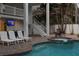 Pool with jacuzzi and lounge chairs for relaxing. Stairs lead up to the multiple decks and levels of the property at 538 Canal Rd, Sarasota, FL 34242