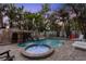 Backyard pool featuring a waterfall, slide, attached jacuzzi, with palm trees surrounding the entertainment area at 538 Canal Rd, Sarasota, FL 34242