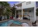 Exterior view of the multi-level balconies and backyard pool area with lounge seating and jacuzzi at 538 Canal Rd, Sarasota, FL 34242