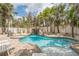 Backyard swimming pool with a waterfall, a slide, and a hot tub surrounded by lush greenery at 538 Canal Rd, Sarasota, FL 34242