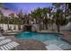 Outdoor pool area featuring a waterfall, hot tub, tropical landscaping, and lounge chairs at 538 Canal Rd, Sarasota, FL 34242