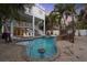 Stunning backyard pool with a unique design, complete with rock waterfall feature, outdoor bar, and multiple lounge areas at 538 Canal Rd, Sarasota, FL 34242