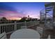 Stunning roof deck featuring a spiral staircase, white railing, and sunset views at 538 Canal Rd, Sarasota, FL 34242