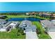Aerial view showcasing the home's location on a lake with beautiful landscaping at 5428 Title Row Dr, Bradenton, FL 34210