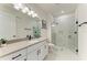 Well-lit bathroom with modern fixtures, large shower, quartz countertops, and white cabinets at 5428 Title Row Dr, Bradenton, FL 34210